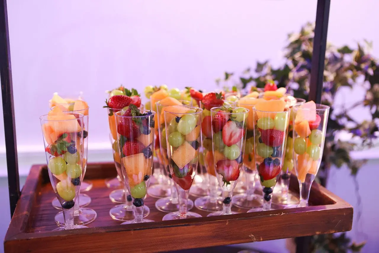 Fruit cups on a hanging rack at a dessert bar at The Heights