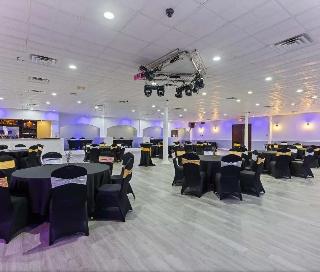 The hall set with black chair covers and purple uplighting, event center Birmingham AL