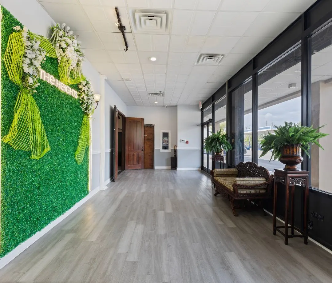 The hall by day with the greenery wall and big windows at The Heights