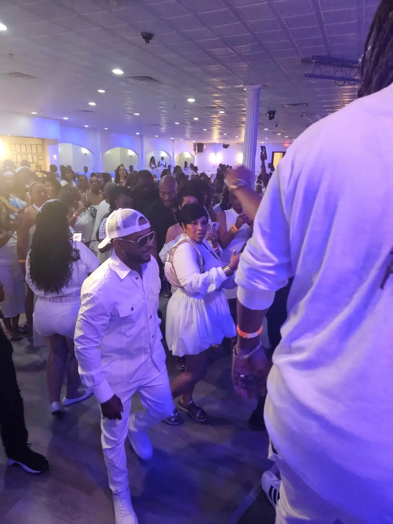A crowded party night under purple lights at The Heights