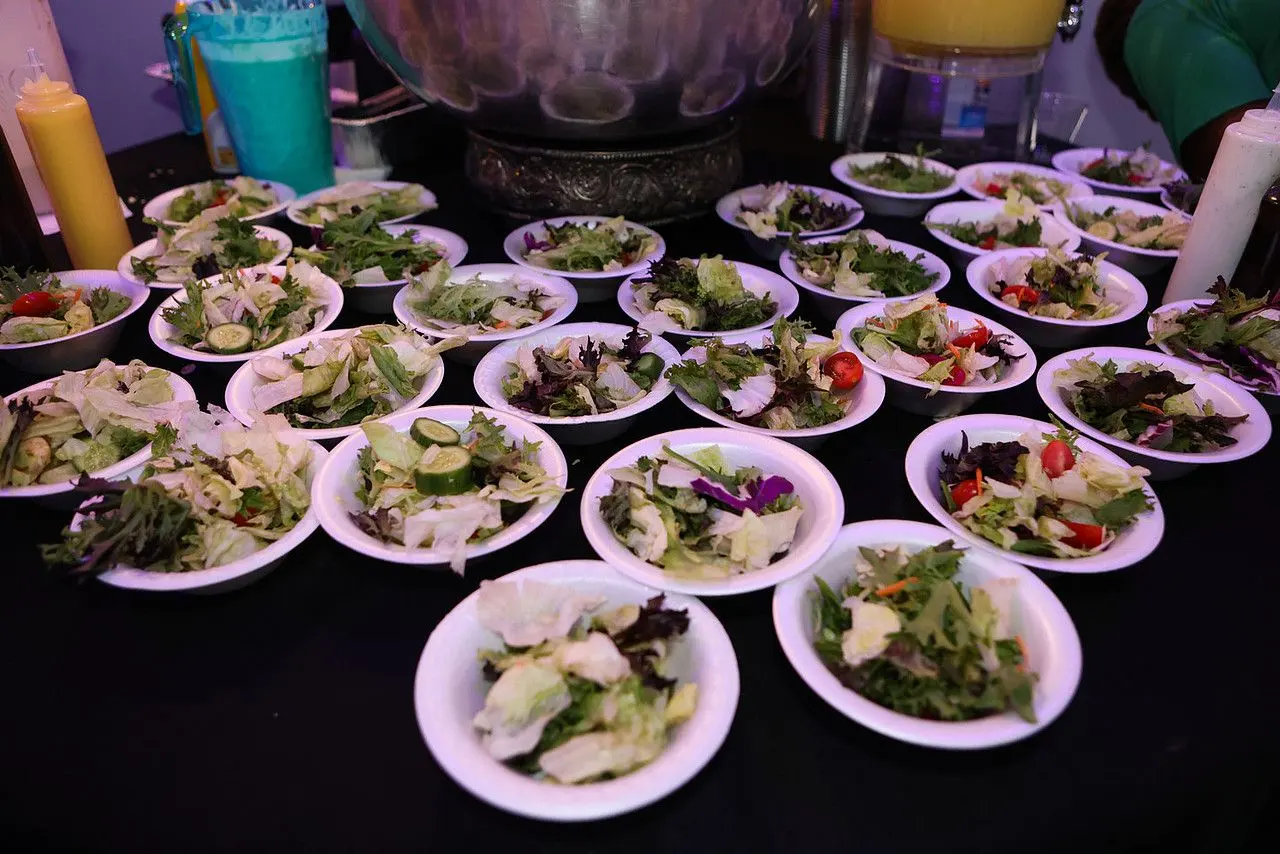 Rows of plated salads ready for a banquet at The Heights